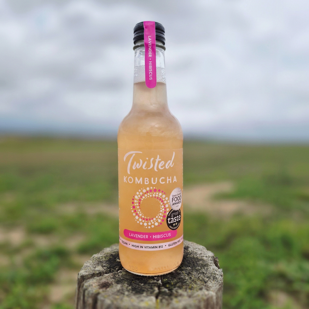Square lavender and hibiscus kombucha on a wooden post